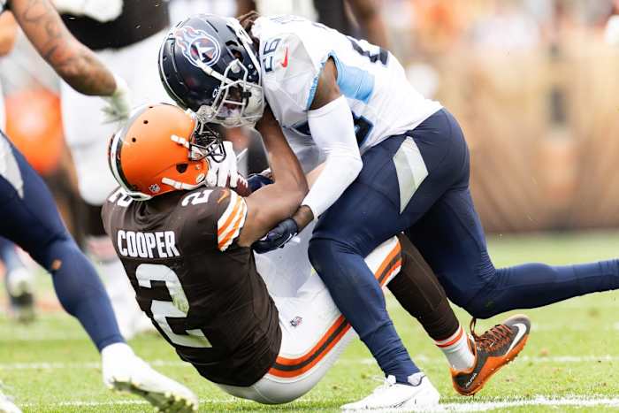 Titans cornerback Kristian Fulton (26) tackles Cleveland Browns wide receiver Amari Cooper (2) during the third quarter at Cleveland Browns Stadium.